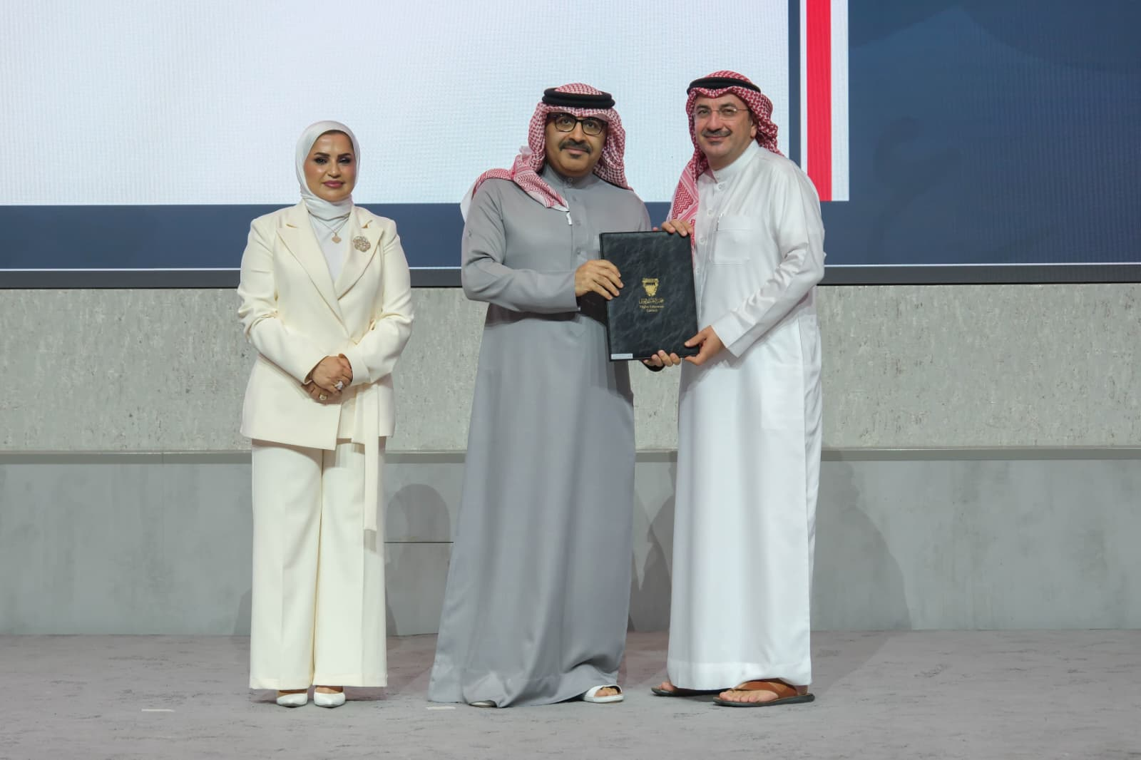 H.E. Dr. Mohamed bin Mubarak Juma, Minister of Education and Chairman of the HEC Board of Trustees, presenting the accreditation renewal certificate to Prof. Mohanad Al-Firas, President of Gulf University, alongside H.E. Dr. Diana Abdulkarim Al-Jahromi, Secretary-General of the Higher Education Council